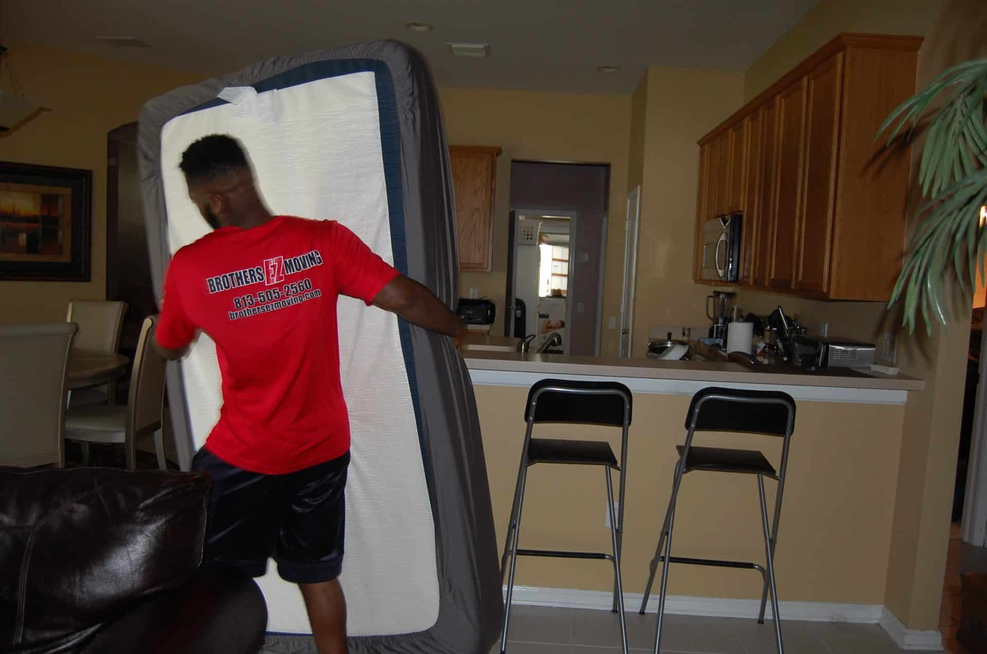 Brothers crew moving furniture inside a home